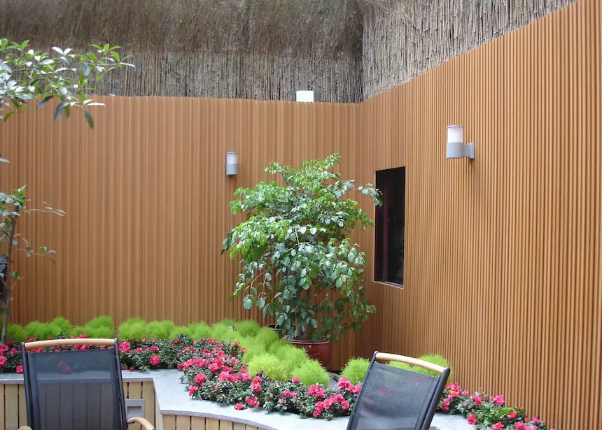 WPC wall panel installation in a backyard garden